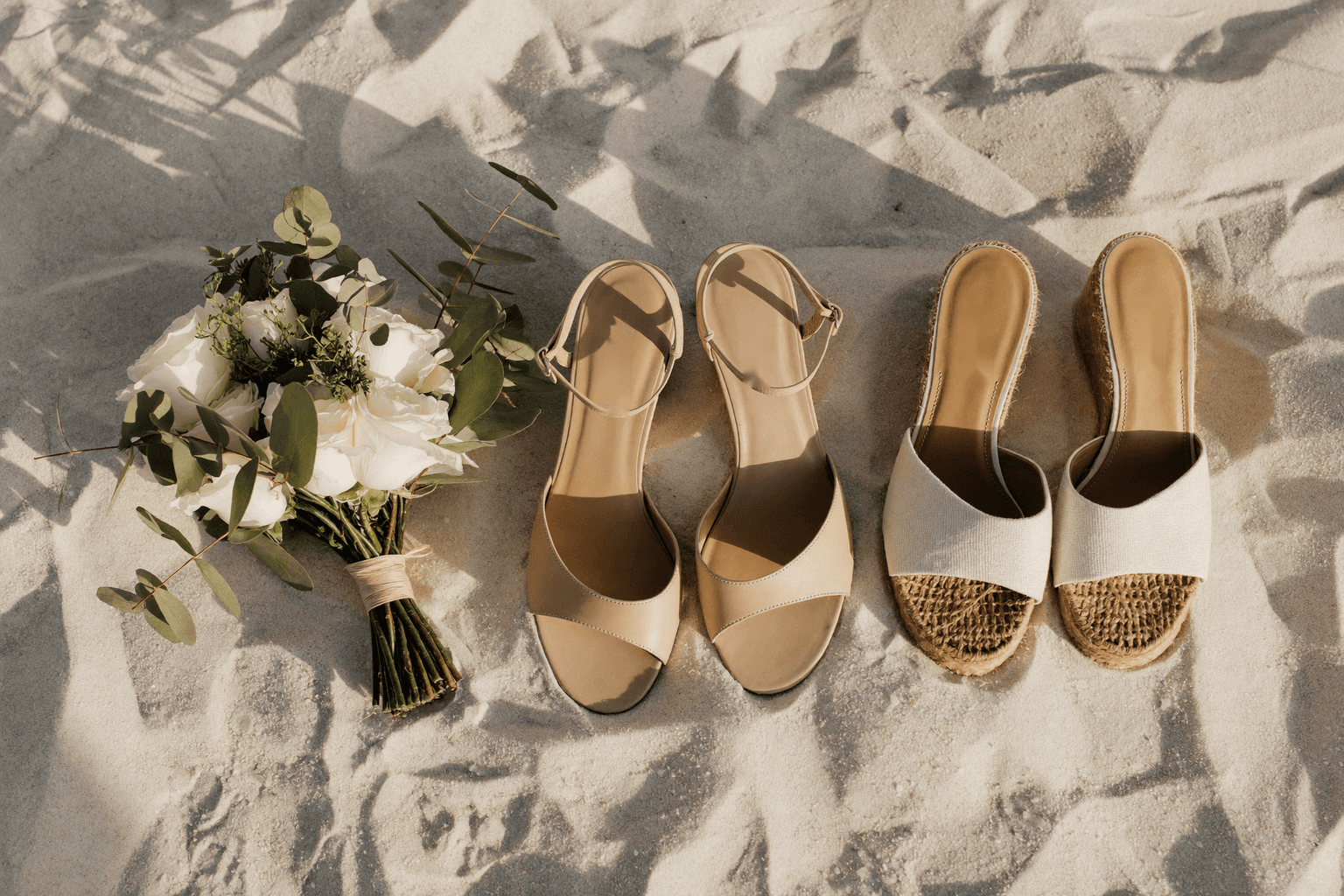 Flat sandals and low wedges on the sand before a Florida beach ceremony
