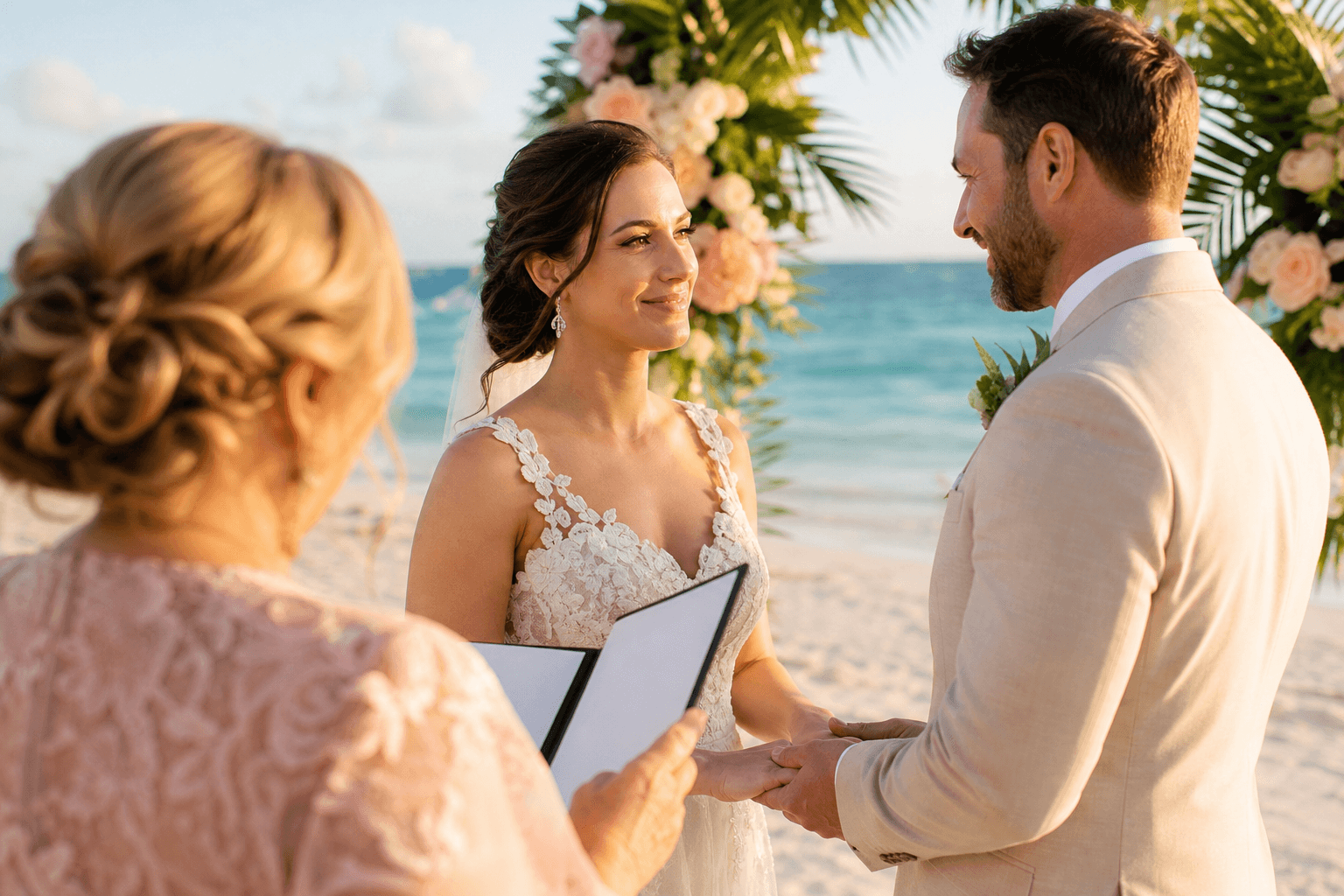 Wedding officiant reading personalized vows to a bride and groom holding hands at a Florida beach ceremony