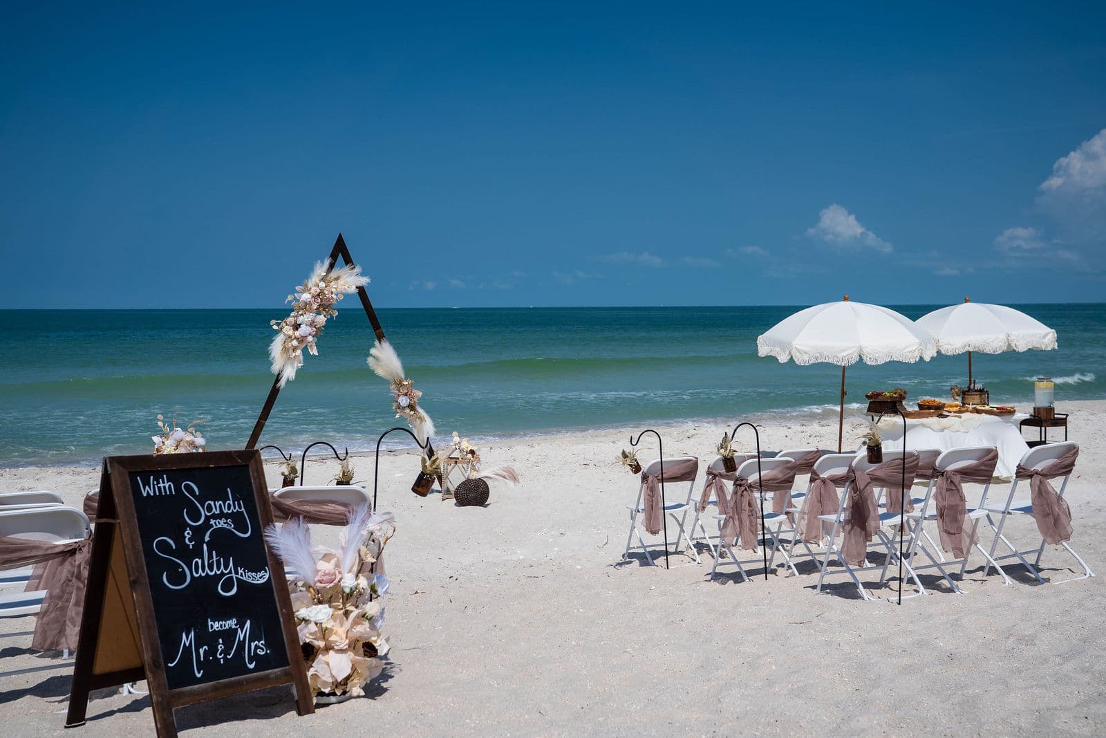 Florida beach wedding guests in resort casual attire at a sunset ceremony