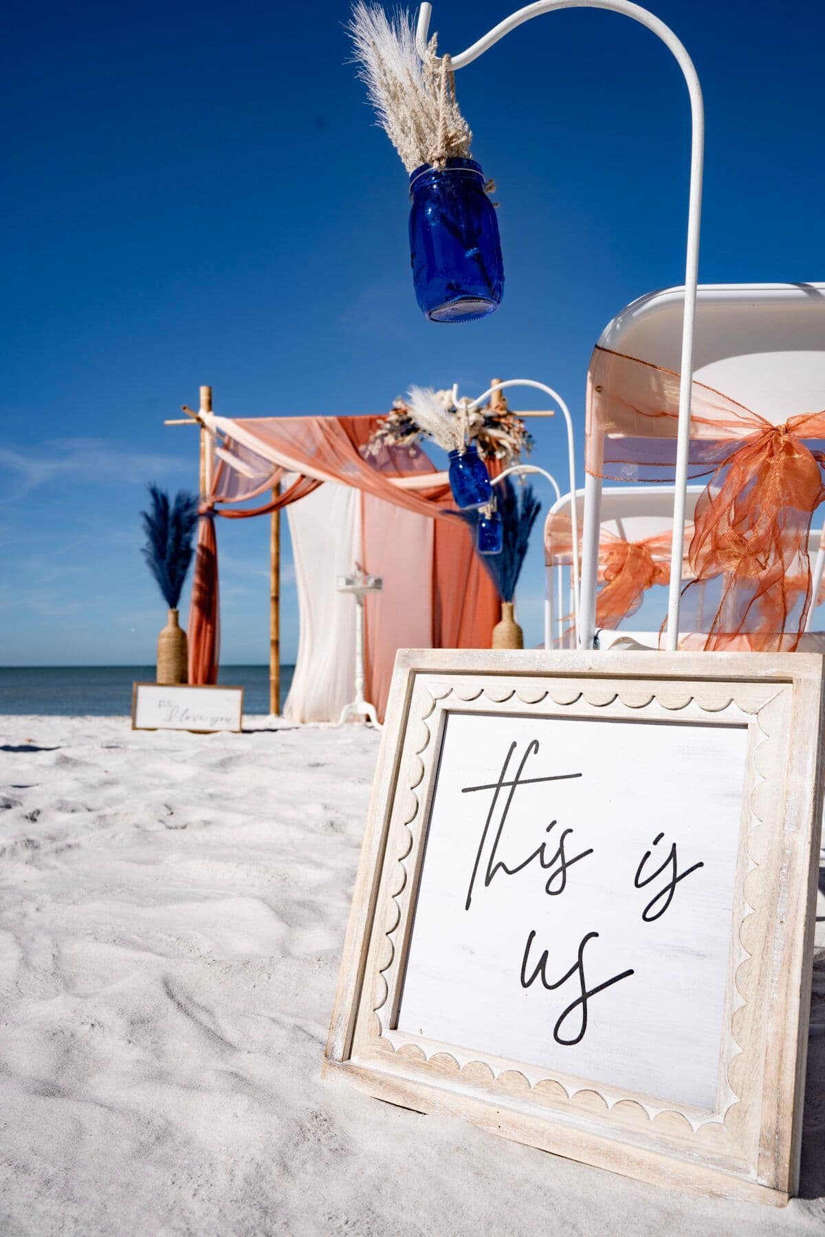Beach wedding setup with rustic boho styling.