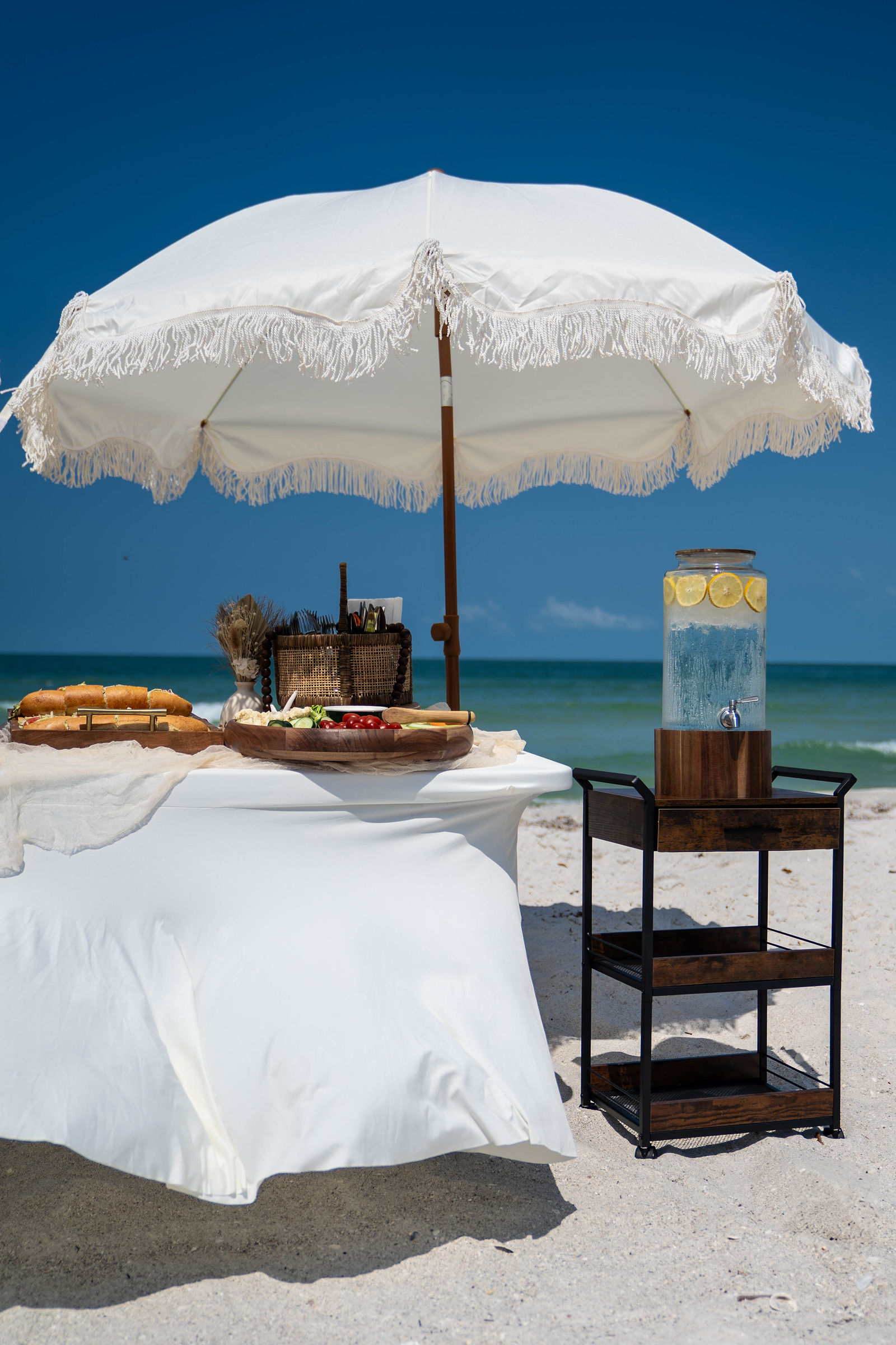 Florida beach wedding celebration with guests gathered near the water at sunset