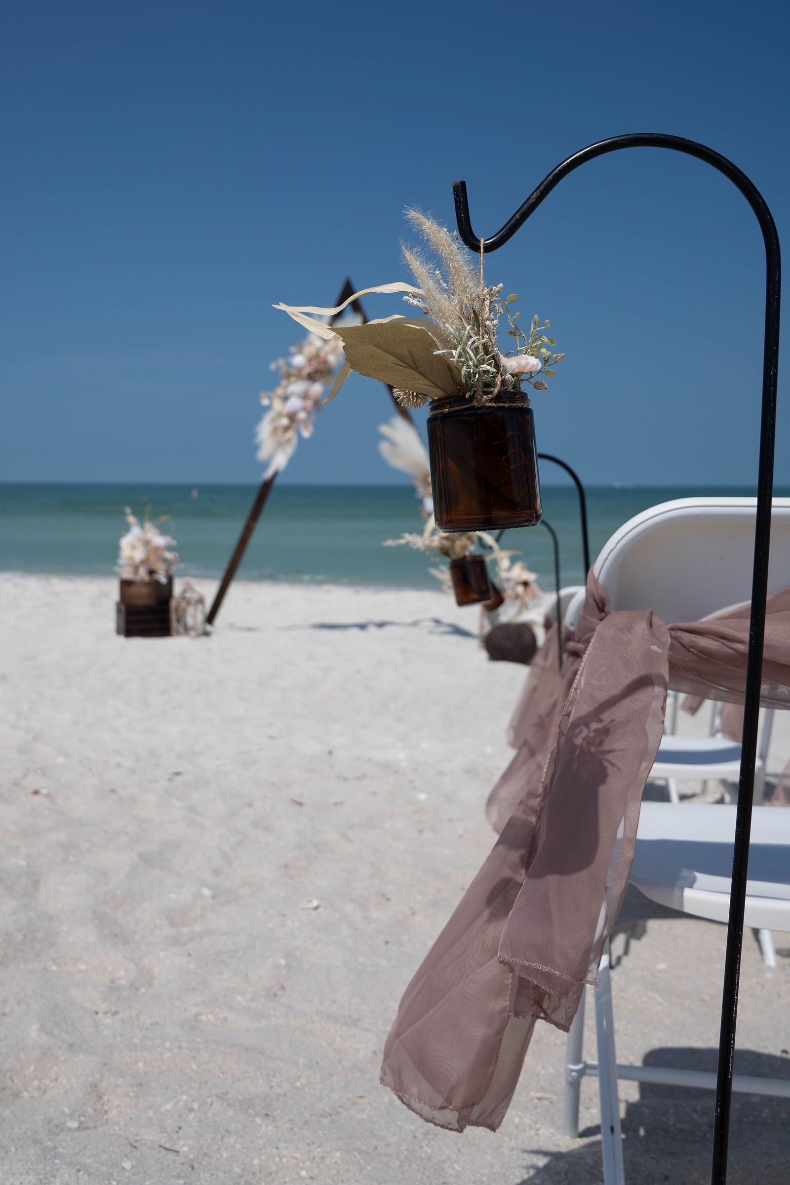 Romantic beach wedding ceremony with couple exchanging vows at sunset in Florida